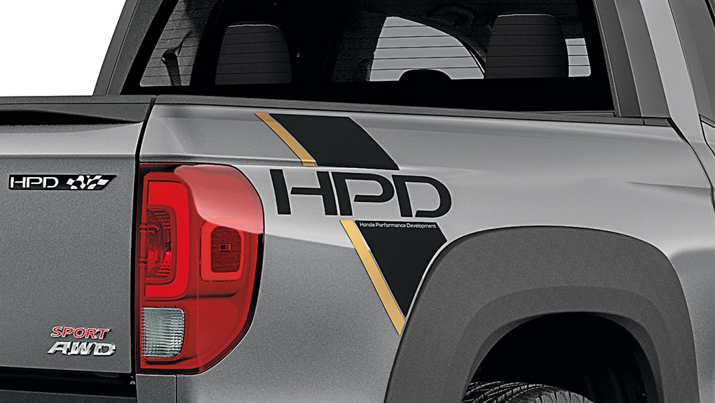 3/4 rearview of Ridgeline with HPD decal on truck-bed side panel.  