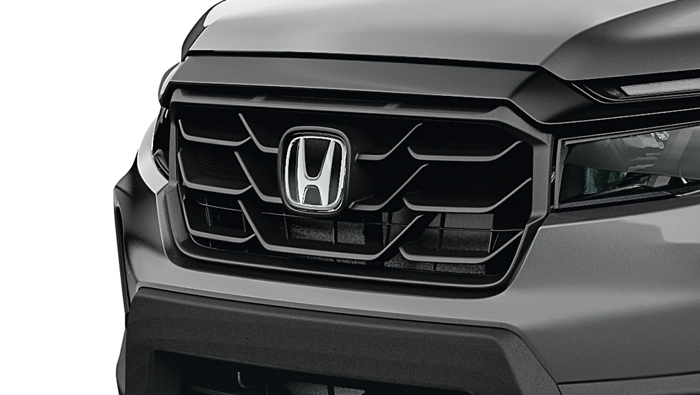  3/4 front view of the Ridgeline’s distinctive grille.