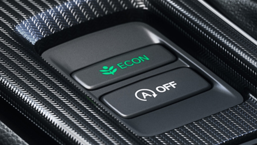 Close-up view of the Eco Assist™ ECON button on the centre console of a 2022 Honda Civic.