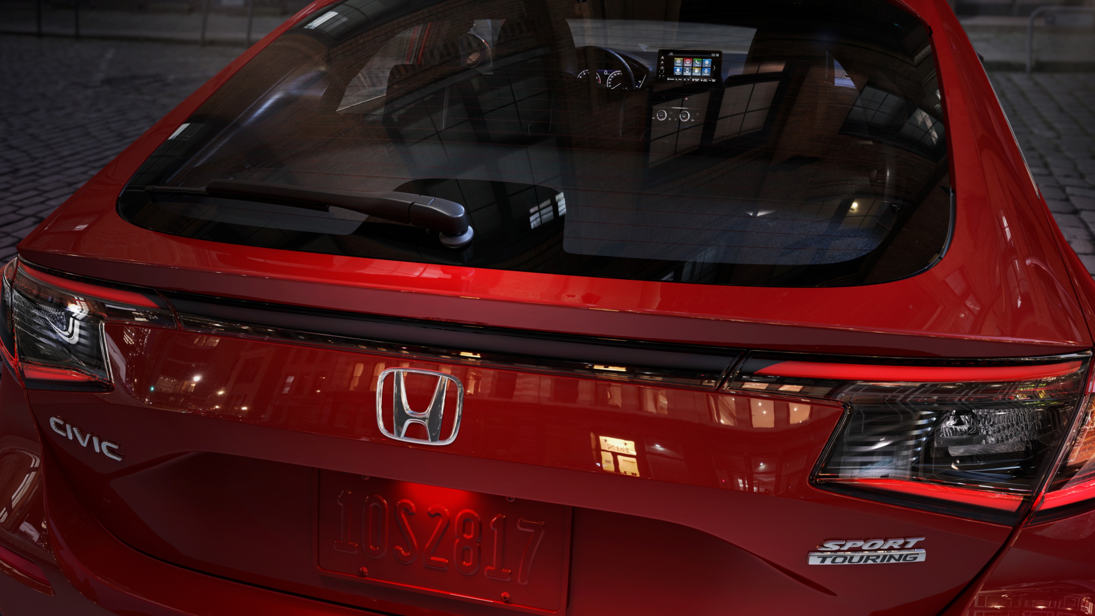 Closed rear door of a red Honda Civic Hatchback Sport Touring model