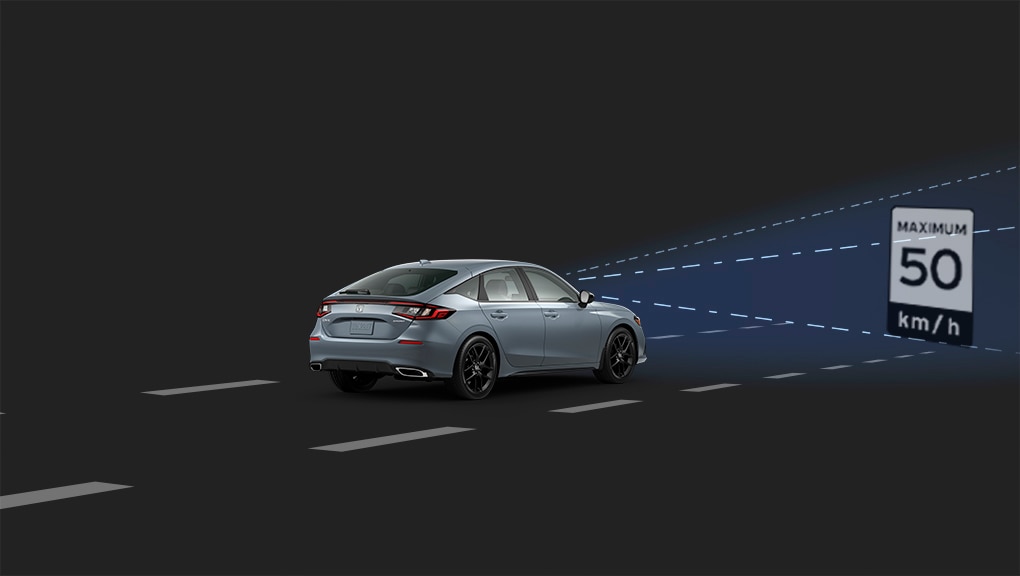 Front, side-angled view of a white 2022 Honda Civic driving in a black space with a blue beam emanating from the front to depict the vehicle’s Traffic sign recognition System.