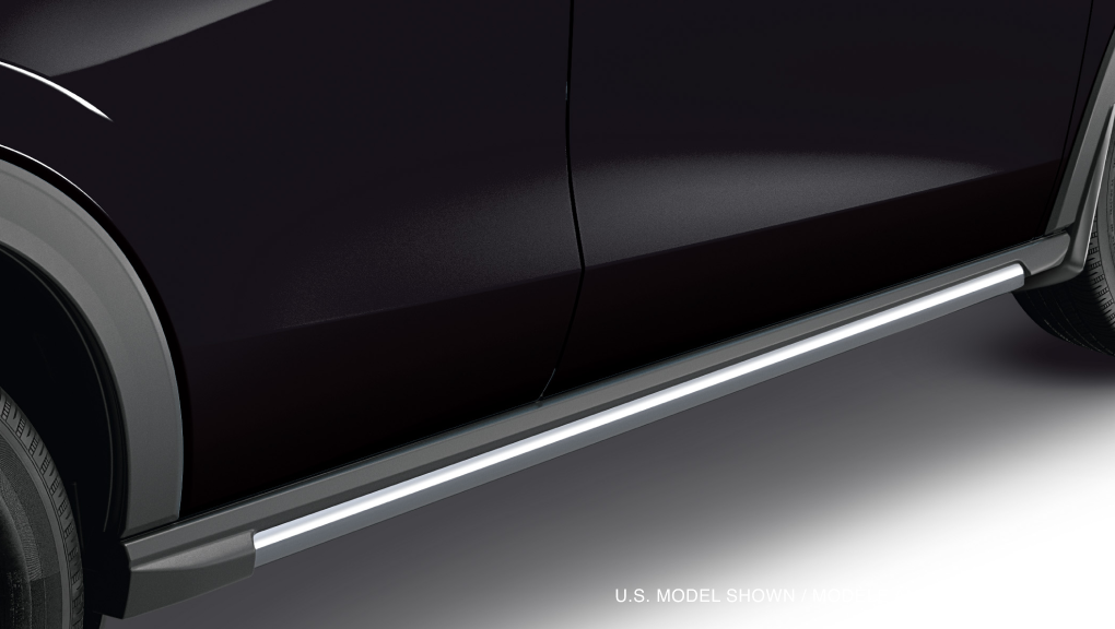 Closeup of metallic grey side lower trim at the bottom of the door on a black HR-V