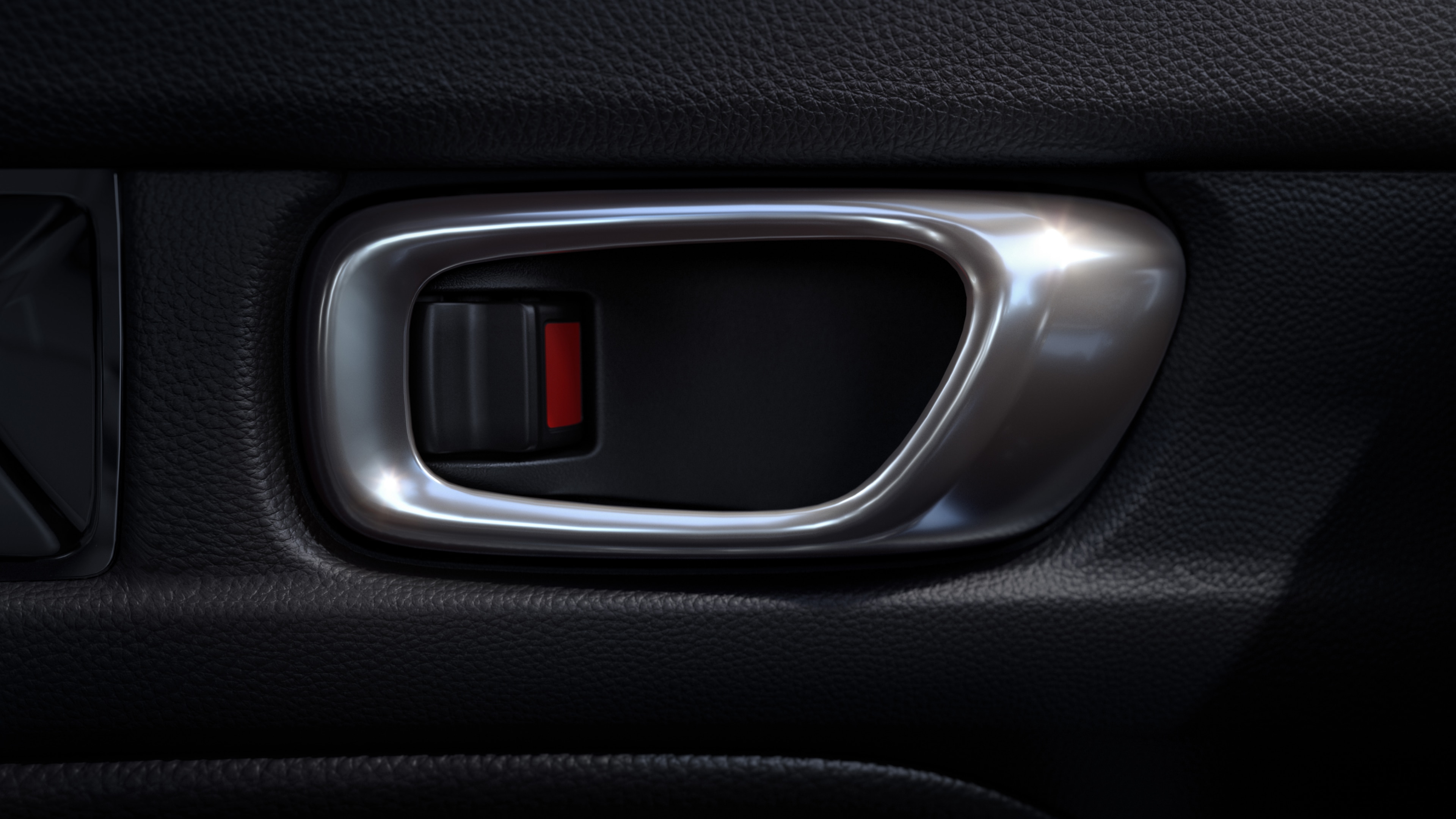 Close-up of silver-coloured Honda Civic Hatchback doorhandle against a black interior