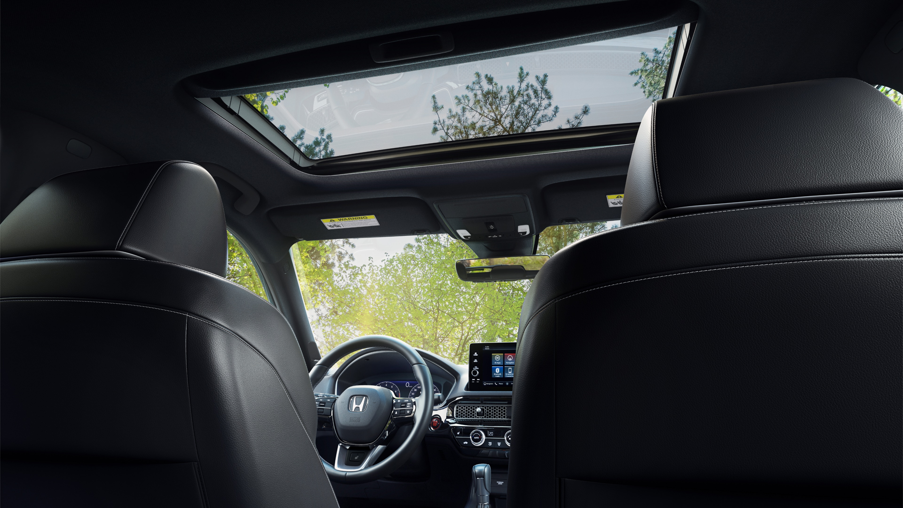 Interior view of Honda Civic Hatchback console and moonroof from the back seat